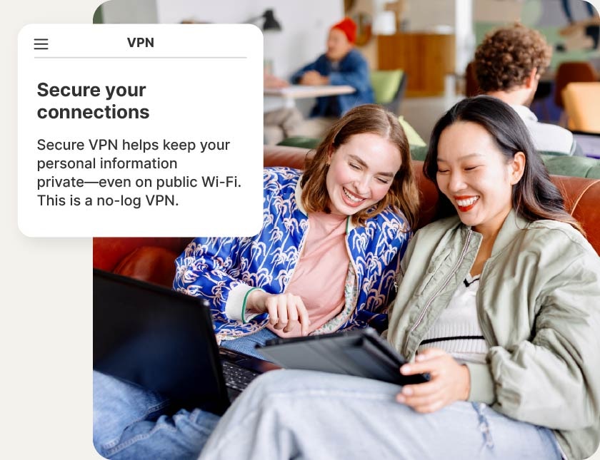 Two women using devices connect to a VPN to secure their connections.