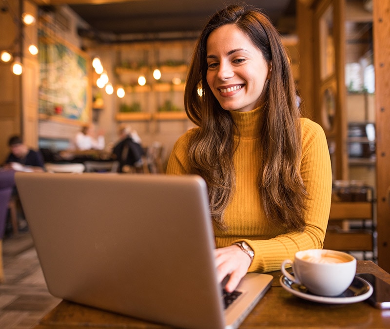 A woman browsing confidently knowing that her data is private with Norton VPN.